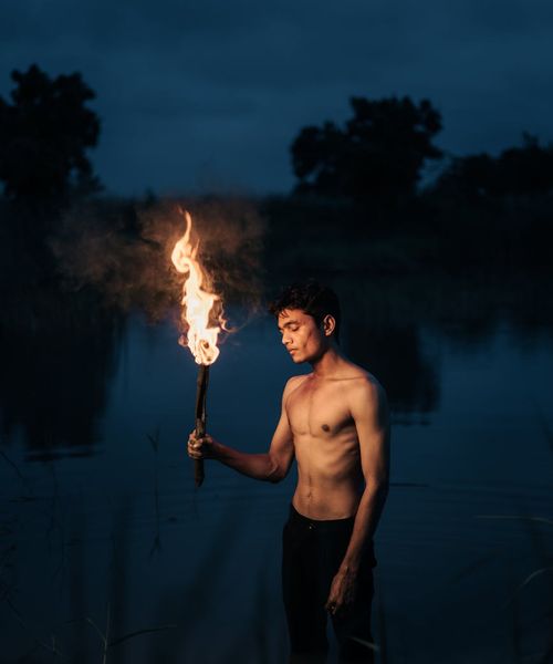 Silhouette of a person standing in a balanced, calm pose against a soft background.