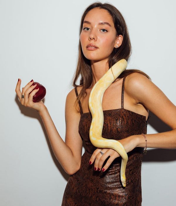 Woman in a dynamic and graceful cardio pose in a light-filled room.